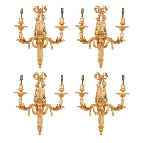 Set of four Louis XVI style ormolu twin light wall lights