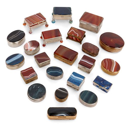 Twenty-two silvered and gilt metal mounted agate pill boxes