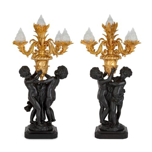 A pair of large Louis XVI style gilt bronze cherub candelabra