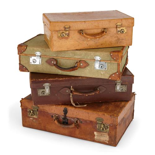 Collection of antique luggage, a set of four English travel cases
