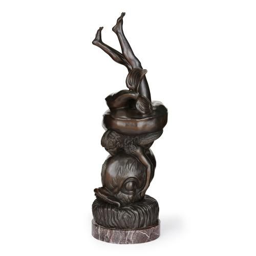Bronze figurative sculpture of Amor with a dolphin